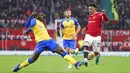 Pemain Southampton Mohammed Salisu (kiri) menghadang pemain Manchester United Jadon Sancho pada pertandingan sepak bola Liga Inggris di Stadion Old Trafford, Manchester, Inggris, 12 Februari 2022. Pertandingan berakhir dengan skor 1-1. (AP Photo/Jon Super)