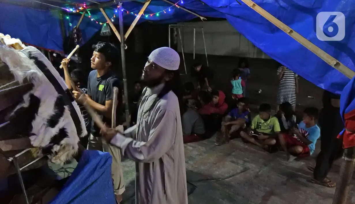 Sejumlah warga memukul bedug pada malam takbiran di kawasan Tanah Baru, Bogor, Jawa Barat, Sabtu (23/5/2020). Di tengah pandemi virus corona COVID-19, sejumlah warga tetap merayakan malam takbiran dengan memukul bedug. (Liputan6.com/Herman Zakharia)