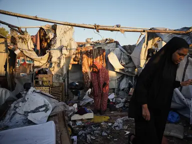 Warga Palestina yang mengungsi memeriksa kerusakan akibat serangan tentara Israel di kamp tenda mereka di Deir al-Balah, Jalur Gaza, Rabu 29 Oktober 2025. Serangan tersebut menyebabkan beberapa warga Palestina tewas, termasuk rusaknya sejumlah tenda pengungsian. (AP Photo/Abdel Kareem Hana)