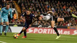 Pemain Barcelona, Jordi Alba berebut bola dengan pemain Valencia, Gabriel pada lanjutan La Liga Primera Division di Stadion Mestalla, Minggu (26/11). Valencia memaksa Barcelona meraih hasil imbang 1-1.  (AFP PHOTO / JOSE JORDAN)