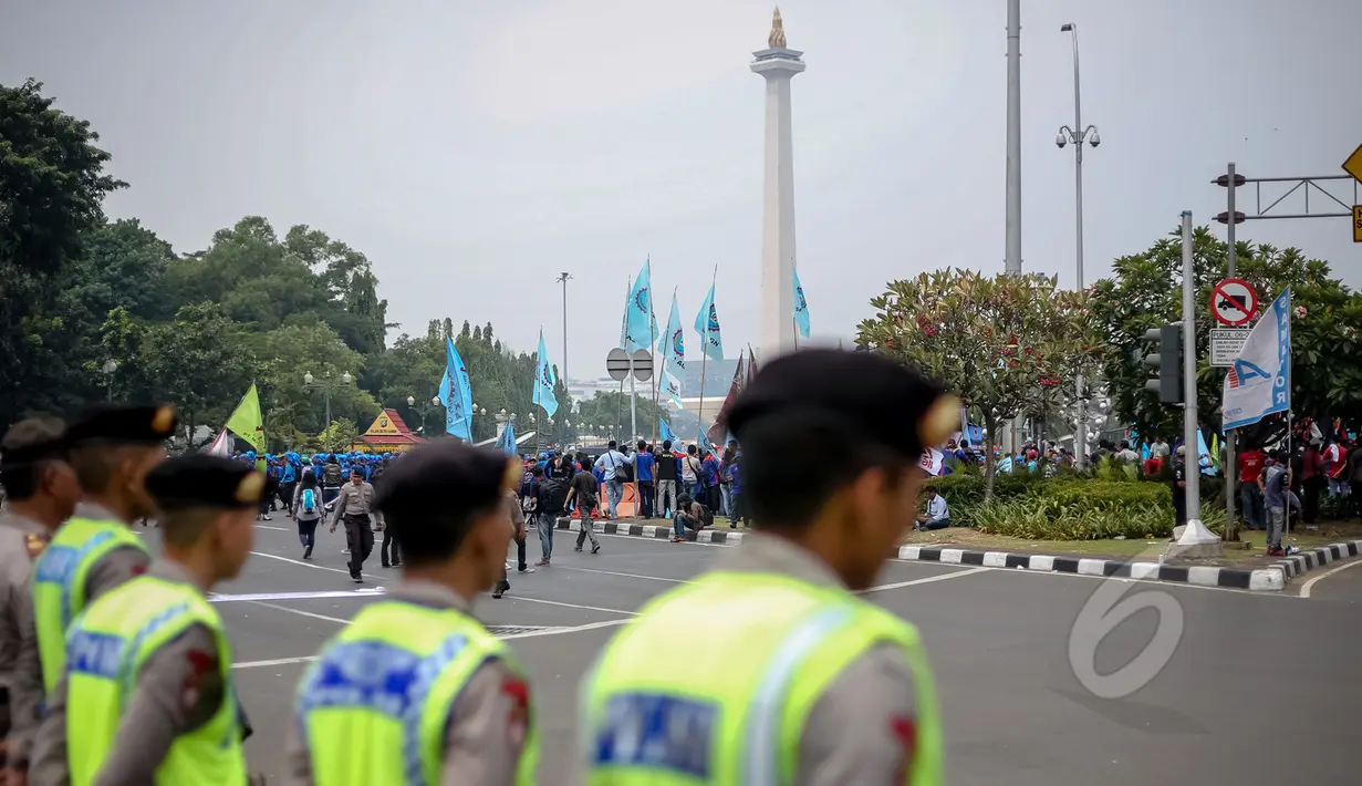 Ribuan buruh berkumpul di kawasan Monas saat peringatan Hari Buruh (May Day), Jakarta, Jumat (1/5/2015). Dalam aksinya, mereka menyampaikan beberapa tuntutan, diantaranya penghapusan sistem kerja kontrak outsourcing. (Liputan6.com/Faizal Fanani)