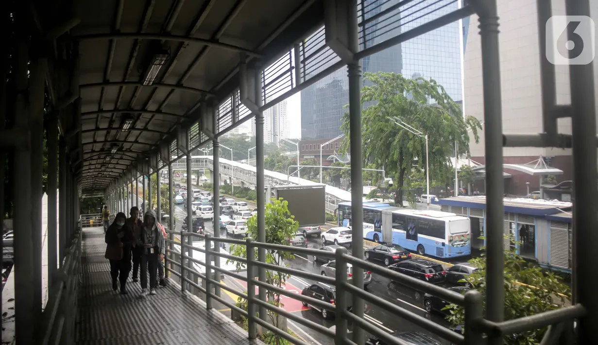 Sejumlah warga melintas di jembatan penyeberangan orang (JPO) dekat Unika Atma Jaya, Jakarta, Rabu (13/11/2019). JPO dekat Unika Atma Jaya dan Hotel Le Meridien di Jalan Jenderal Sudirman akan dicopot karena tidak berhubungan dengan halte Transjakarta. (Liputan6.com/Faizal Fanani)