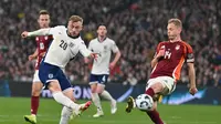 Pemain Inggris, Jarrod Bowen, melepaskan tendangan tanpa mampu diadang bek Latvia, Andrejs Ciganiks, dalam lanjutan Kualifikasi Piala Dunia 2026 Zona Eropa, Selasa (25/3/2025) dini hari WIB. (Glyn KIRK / AFP)