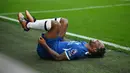 Pemain Chelsea, Raheem Sterling, meringis kesakitan setelah dilanggar pemain Burnley, Vitinho, pada laga pekan ke-8 Premier League 2023/2024 di Stadion Turf Moor, Sabtu, (7/10/2023). (AFP/Oli Scarff)