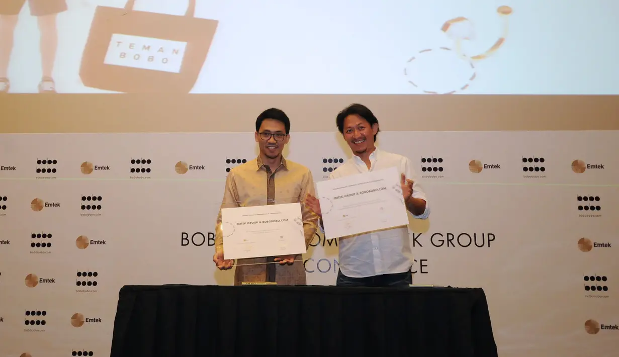 Direktur Utama EMTEK Grup, R. Alvin Widarta Sariaatmadja (kiri) bersama dengan Jimmy Akili, CEO dan pendiri Bobobobo.com memperlihatkan nota kerjasama usai menggelar jumpa pers di SCTV Tower, Jakarta, Rabu (29/4/2015). (Liputan6.cm/Helmi Fithriansyah)