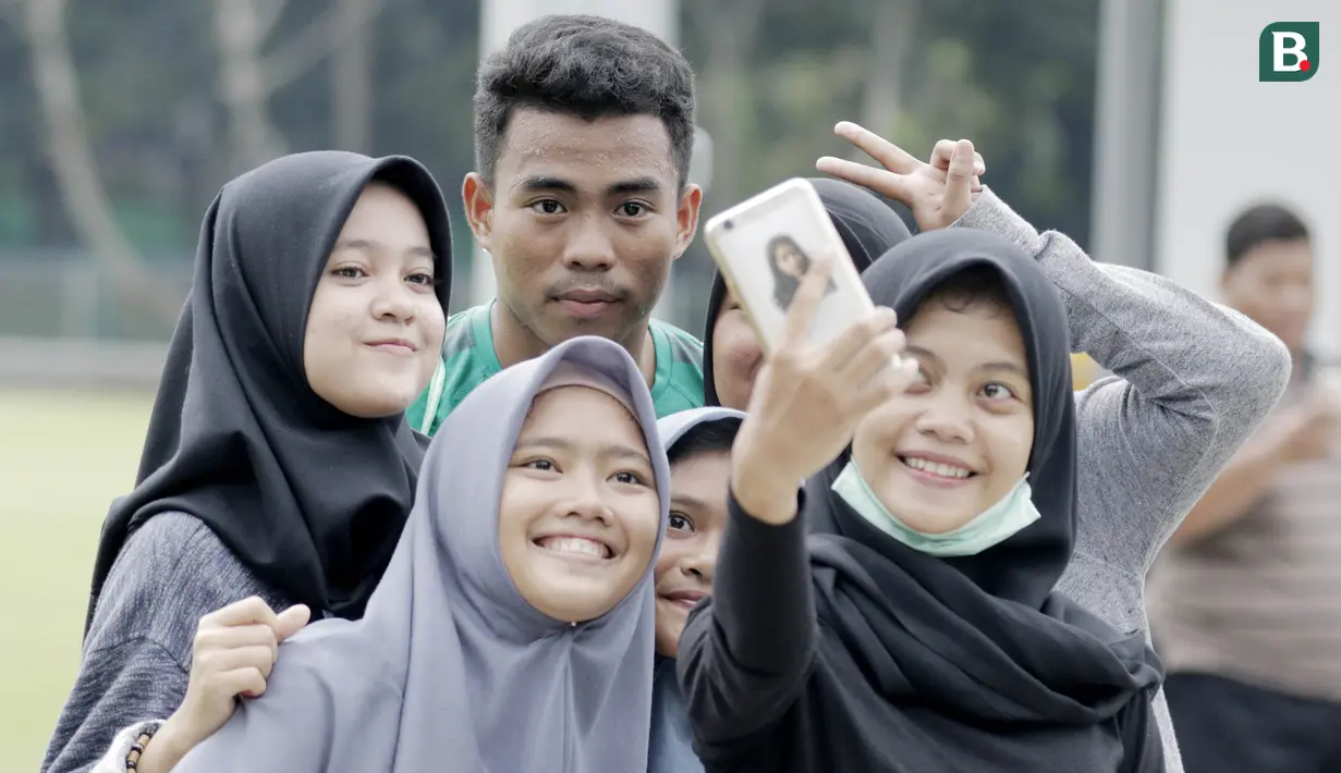 Bek Timnas Indonesia, Nurhidayat Haris, foto bersama fans usai latihan di Lapangan ABC Senayan, Jakarta, Kamis (22/2/2018). Latihan ini dilakukan untuk persiapan Piala AFF U-18 2018 dan Piala Asia U-19 2018. (Bola.com/M Iqbal Ichsan)
