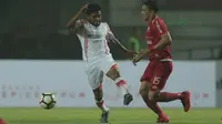 Pemain Persipura Jayapura, Emanuel Wanggai (kiri) menghalau bola dari kejaran pemain Persija, Addison Alves pada lanjutan Liga 1 Gojek bersama Bukalapak di Stadion Pakansari, Bogor, (25/5/2018).  Persija menang 2-0. (Bola.com/Nick Hanoatubun)