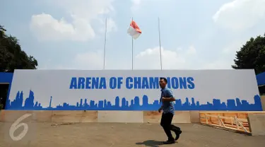 Seseorang melintas di depan banner arena champions di Istora Senayan, Jakarta, Jumat (7/8/2015). Jelang perhelatan Kejuaraan Bulutangkis Dunia 2015, sejumlah persiapan terus dilakukan pihak panitia pelaksana. (Liputan6.com/Helmi Fithriansyah)