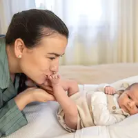 Potret ibu muda dan bayi baru lahirnya yang menggemaskan dan bahagia sedang bermain bersama. (Foto dok: Freepik/Pvproductions).