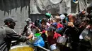 Mengutip data dari Kantor Koordinasi Urusan Kemanusiaan (OCHA), Juru Bicara PBB Stephane Dujarric, menyatakan ada sekitar 2,1 juta orang di Gaza kini terkurung di kurang dari setengah wilayahnya. Tampak dalam foto, orang-orang berebut untuk mendapatkan makanan hangat di kamp pengungsi Palestina, Nuseirat, Jalur Gaza Tengah pada Kamis 7 Mei 2026. (Eyad Baba/AFP)