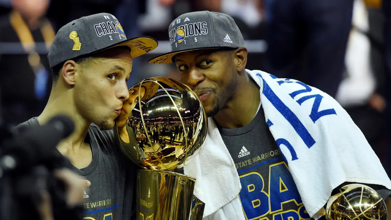 Stephen Curry dan Andre Iguodala menggenggam Trofi Larry O'Brien