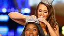 Miss New York Nia Franklin menerima mahkota Miss America 2019 dari pemenang tahun lalu Cara Mund di Atlantic City, New Jersey (9/10). Franklin, puteri James dan Kristy Franklin, juga seorang advokat. (AP Photo/Noah K. Murray)