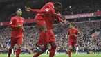 Para pemain Liverpool merayakan gol yang dicetak Divock Origi ke gawang Everton pada laga Liga Inggris di Stadion Anfield, Inggris, Sabtu (1/4/2017). Liverpool berhasil menang 3-1 atas Everton. (AFP/Paul Ellis)