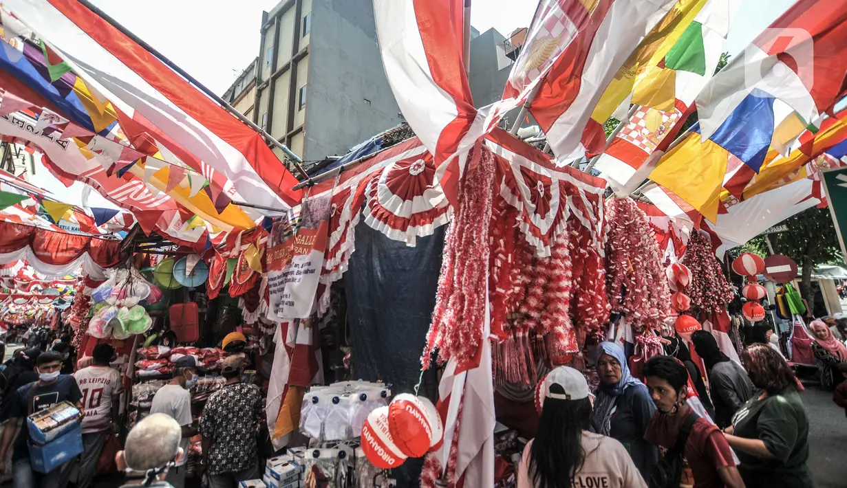 Calon pembeli saat memilih koleksi di salah satu toko pernak-pernik HUT Kemerdekaan RI di Pasar Jatinegara, Jakarta, Minggu (8/8/2021). Penjualan bendera dan pernak-pernik Kemerdekaan RI merosot karena pandemi COVID-19 berkepanjangan dan larangan merayakan lomba 17-an. (merdeka.com/Iqbal S. Nugroho)