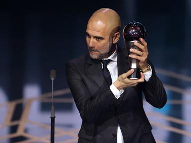Pelatih Manchester City, Pep Guardiola mendapatkan penghargaan pelatih terbaik FIFA 2023 pada acara Best FIFA Football Awards yang berlangsung di Eventim Apollo, Hammersmith, London, Senin (15/01/2024) waktu setempat. Hal itu menyusul performa gemilangnya membawa The Cityzens memenangkan treble pada tahun lalu, yaitu Liga Inggris, Piala FA, dan Liga Champions. Guardiola memenangi penghargaan itu setelah mengumpulkan 28 poin, mengungguli Luciano Spalletti (Napoli), dan Simone Inzaghi (Inter Milan) dalam pemungutan suara. Pelatih berkebangsaan Spanyol itu unggul 10 angka dari Spalletti, dan 17 angka dari Inzaghi. (AFP/Adrian Dennis)