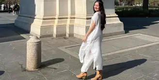 Beby Tsabina membagikan beberapa potret Lebaran pertamanya yang jauh dari rumah. Dalam beberapa foto, ia memamerkan dirinya mengenakan kaftan dress berwarna putih yang cantik. Foto: Instagram.