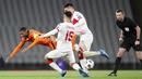 Gelandang Belanda, Georginio Wijnaldum, terjatuh saat berebut bola dengan bek Turki, Ozan kabak, pada laga kualifikasi Piala Dunia 2022 di Stadion Olimpiade Ataturk, Kamis (25/3/2021). Turki menang dengan skor 4-2. (Tolga Bozoglu/Pool Photo via AP)