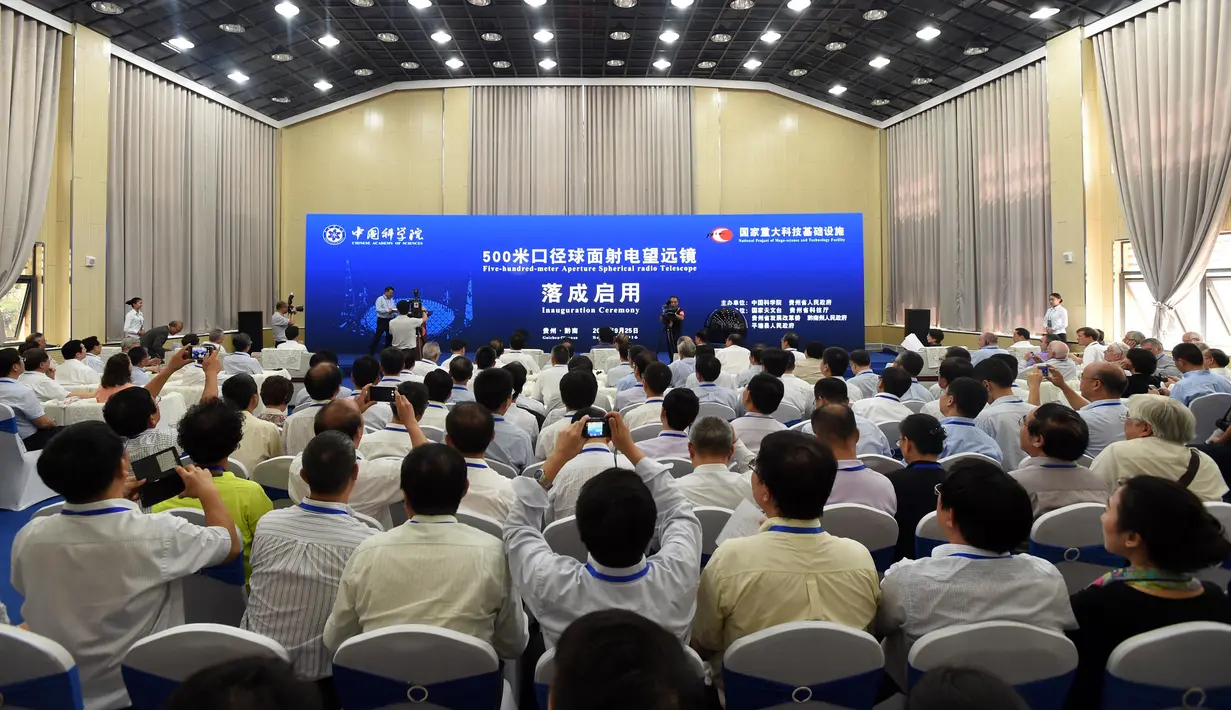 Tamu undangan menghadiri peresmian teleskop terbesar di dunia, Aperture Spherical Telescope atau FAST di Pingtang, Guizhou, China, Minggu (25/9). Teleskop raksasa ini mampu mendeteksi sinyal radio dan tanda-tanda kehidupan di planet lainnya. (STR/AFP)