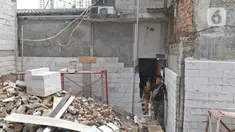 Salah satu kerabat pemilik rumah saat keluar dari rumah di kawasan Mangga Dua Dalam, Jakarta, Kamis (12/12/2019). Sebuah rumah di kawasan Mangga Dua terhimpit oleh bangunan yang sedang dibangun. (Liputan6.com/Herman Zakharia)