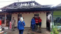 Tim pemadam kebakaran Dinas Pemadam Kebakaran Banyuwangi berjibaku memadamkan api  yang melalap rumah warga di Kelurahan Tukang Kayu. (Hermawan Arifianto/Liputan6.com)