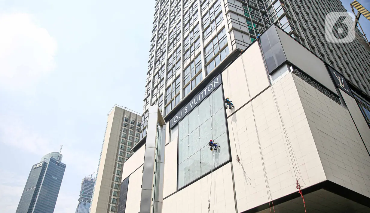 Pekerja membersihkan gedung di kawasan Thamrin, Jakarta, Rabu (21/10/2020). Berdasarkan data BPJamsostek, angka klaim kecelakaan kerja pada semester I 2020 dari Januari sampai Juni 2020 meningkat 128 persen atau naik dari sebelumnya 85.109 kasus menjadi 108.573 kasus. (Liputan6.com/Faizal Fanani)