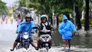 Beberapa kendaraan, baik sepeda motor maupun mobil ikut terendam dan tidak dapat melintas. Tampak dalam foto, para pengendara sepeda motor melaju melewati air di jalan yang tergenang banjir akibat hujan lebat di Legian Kuta, Denpasar, Bali, pada Selasa 24 Februari 2026. ((SONNY TUMBELAKA/AFP)