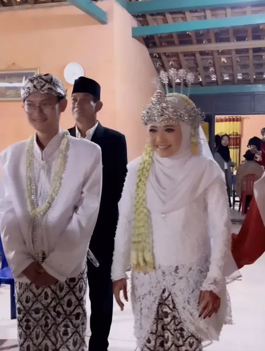 Kedua mempelai berbahagia ini tampil dengan baju adat sunda serba putih lengkap mengenakan kain lilit batik yang serasi sebagai bawahannya. [@ashanty_ash]