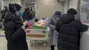 Seorang pasien lansia beristirahat di dekat konter pengambilan obat saat orang menunggu di bangsal darurat sebuah rumah sakit di Beijing, Kamis (5/1/2023). Pasien, kebanyakan dari mereka lansia, berbaring di tandu di lorong dan menerima oksigen sambil duduk di kursi roda saat kasus COVID-19 melonjak di ibu kota China, Beijing. (AP Photo/Andy Wong)
