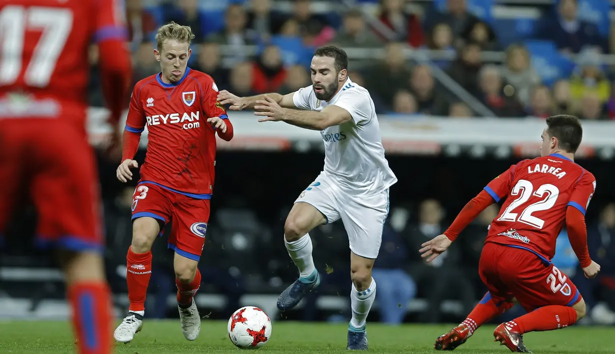 Aksi pemain Real Madrid, Jose Luis Fernandez "Nacho", (tengah) melewati adangan para pemain Numancia pada laga Copa Del Rey di Santiago Bernabeu stadium, Madrid, (10/01/2018). Real Madrid unggul agregat 5-2 atas Numancia. (AP/Francisco Seco)