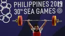 Lifter Eko Yuli melakukan angkatan saat SEA Games 2019 cabang angkat besi nomor 61 kg di Stadion Rizal Memorial, Manila, Filipina, Minggu (1/12/2019). Dirinya meraih emas dengan total angkatan 309 kg. (Bola.com/M Iqbal Ichsan)