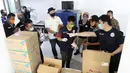 Petugas mengecek bantuan berupa 10.000 masker kain, 5.000 masker medis, APD, sepatu boot dan hand sanitizer di Balaikota Jakarta, Kamis (9/4/2020). Bantuan HIPMI Jaya dan APPI tersebut guna meringankan warga Jakarta selama masa pandemi Corona Covid-19. (Liputan6.com/Fery Pradolo)