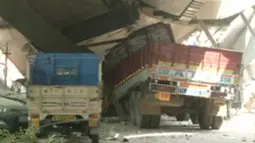 Kendaraan terlihat terjebak di runtuhan sebuah jembatan layang yang ambruk di Kolkata, India, Kamis (31/3). Setidaknya 10 orang tewas dan sekitar 150 orang lainnya tertimpa reruntuhan. (REUTERS/ANI via Reuters)