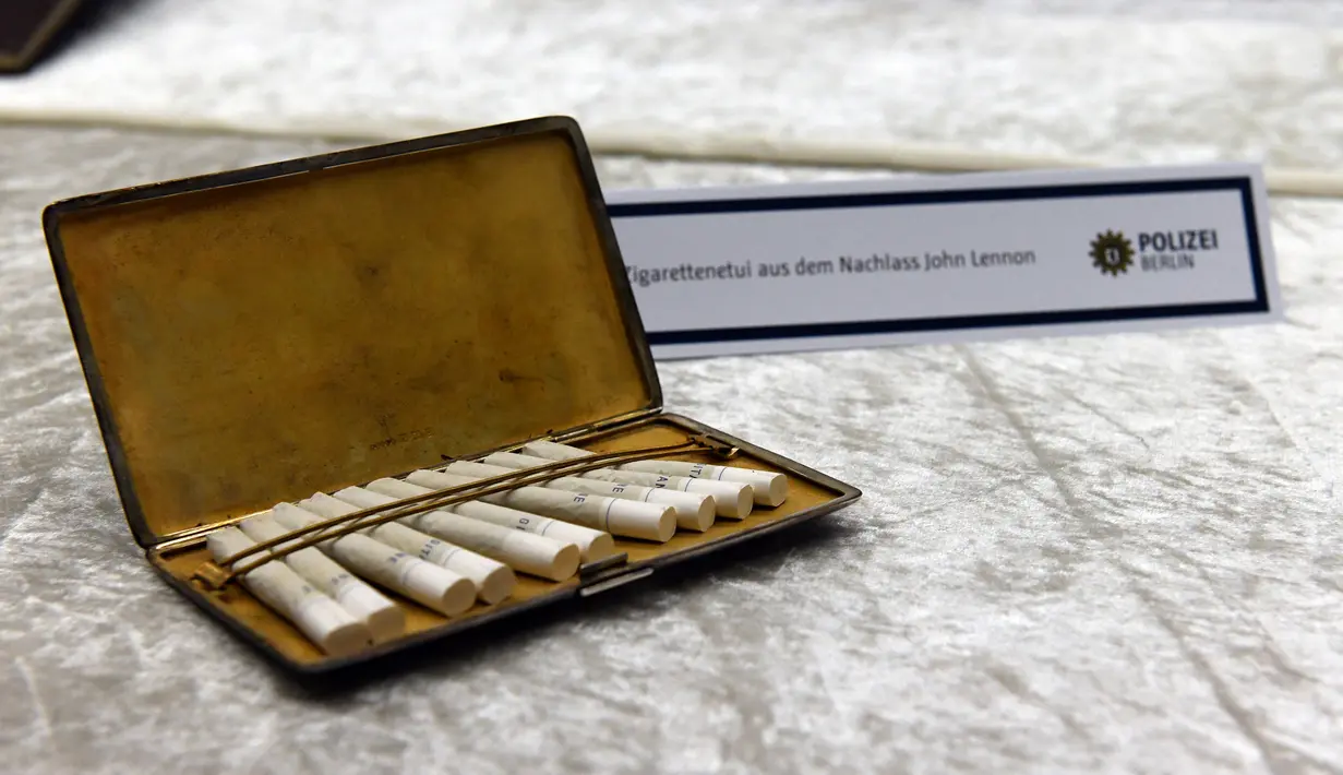 Sebuah kotak rokok milik mantan personel The Beatles, John Lennon yang sempat dicuri diperlihatkan di Berlin, Selasa (21/11). Barang-barang milik Lennon sebagai musisi nan legendaris, memang menjadi rebutan kolektor. (Maurizio Gambarini/dpa/AFP)