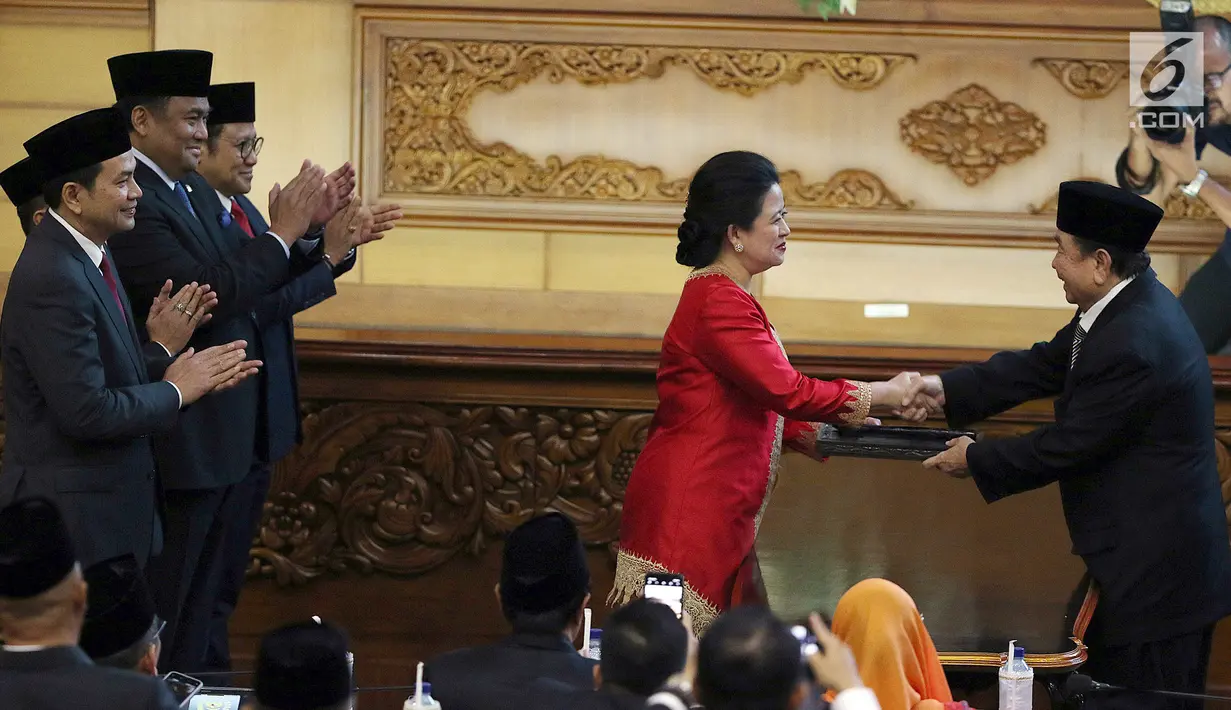 Ketua DPR Puan Maharani (tengah) berjabat tangan dengan Abdul Wahab Dalimunthe saat Rapat Paripurna ke-2 di Kompleks Parlemen, Jakarta, Selasa (1/10/2019). Puan Maharani resmi menjadi Ketua DPR periode 2019-2024. (Liputan6.com/JohanTallo)