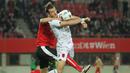 Bek Austria, Aleksander Dragovic (kiri) merangkul leher penyerang Albania, Sokol Cikalleshi, yang hendak menerima umpan lambung pada laga uji coba di Stadion Ernst Happel, Wina, Minggu (27/3/2016) dini hari WIB. (Bola.com/Reza Khomaini)