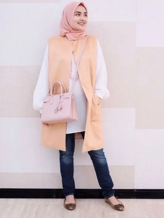 Cocok untuk hangout, kamu bisa memadukan layering tunic dengan celana jeans dan sling bag seperti desainer Ria Miranda satu ini. (Instagram/riamiranda).