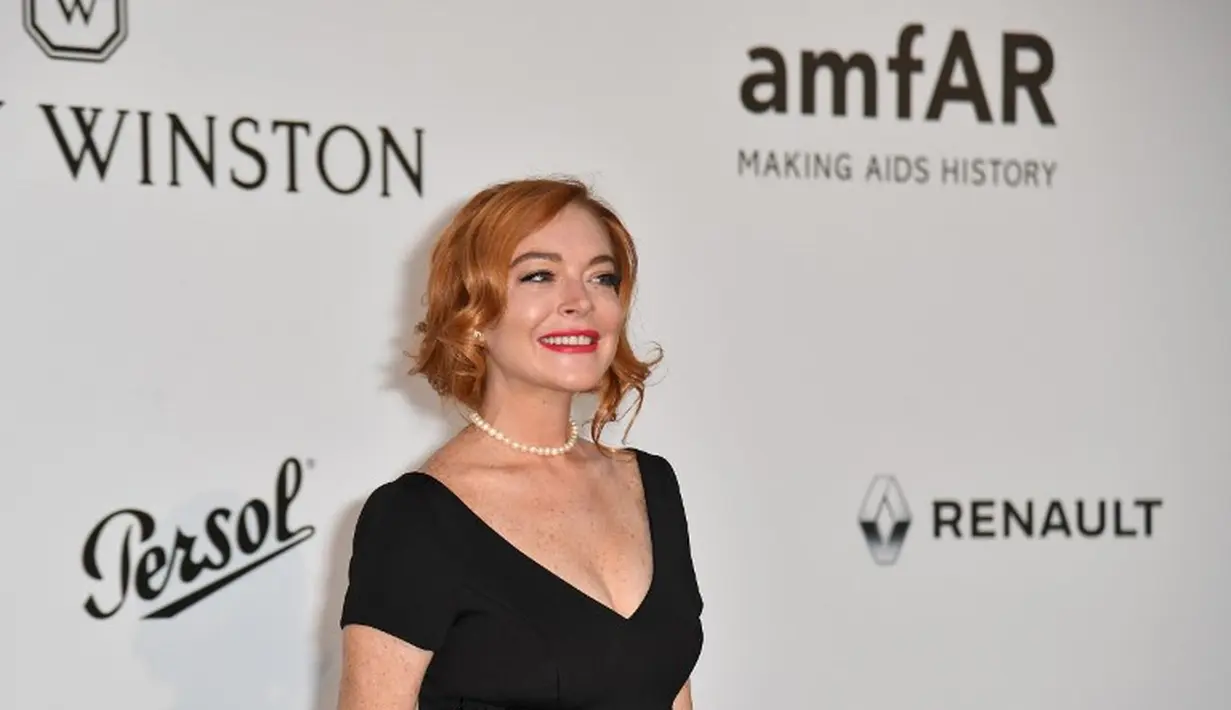 Lindsay Lohan sendiri kini sudah meninggalkan Amerika Serikat untuk menetap di London. Namun kini, dirinya tinggal di Dubai dan seringkali pergi ke Miami pada akhir pekan. (ALBERTO PIZZOLI / AFP)