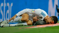Pemain Real Madrid, Cristiano Ronaldo tergeletak di lapangan setelah terjatuh dalam lanjutan La Liga 2017/2018 melawan Espanyol di Santiago Bernabeu, Minggu (1/10). Real Madrid sukses menundukkan Espanyol dua gol tanpa balas. (AP/Paul White)