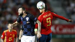 Striker Spanyol, Rodrigo Moreno, duel udara dengan gelandang Kroasia, Marcelo Brozovic, pada laga UEFA Nations League di Stadion Manuel Martinez Valero, Selasa (11/9/2018). Spanyol menang 6-0 atas Kroasia. (AP/Alberto Saiz)