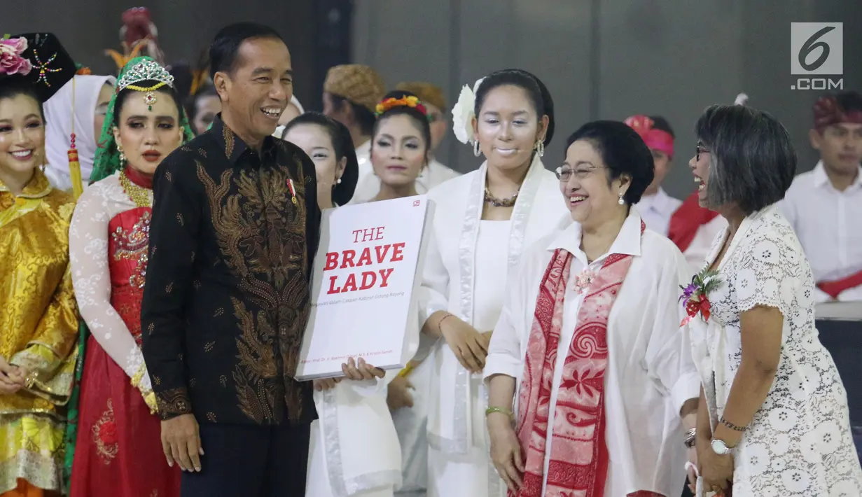 Presiden Joko Widodo menghadiahi buku pada HUT ke-72 Ketua Umum PDIP Megawati Soekarnoputri di Grand Sahid Jakarta, Rabu (23/1). Para menteri Kabinet Gotong Royong menghadiahkan buku berjudul The Brave Lady kepada Megawati. (Liputan6.com/Angga Yuniar)