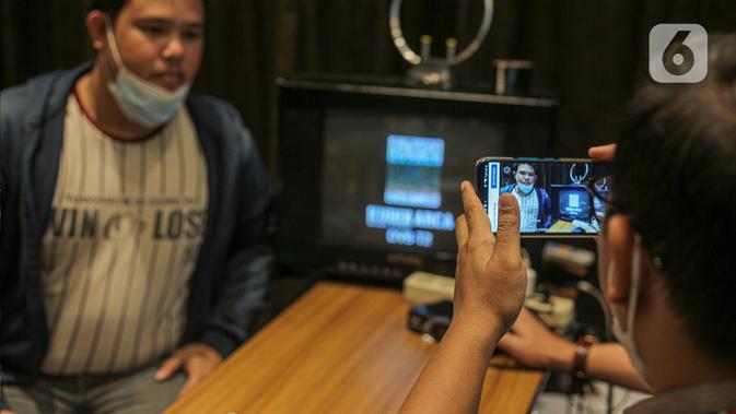 Petugas Kementerian Kominfo (Komunikasi dan Informatika) mengambil gambar warga yang mendapatkan alat STB atau Set Top Box secara gratis di Posko Respon Cepat Penanganan Bantuan STB di Hotel Akmani, Jakarta, Kamis (3/11/2022). Pemerintah memulai migrasi siaran TV analog ke TV digital atau Analog Swicth Off (ASO) pada 2 November 2022 pukul 24.00 WIB yang dilakukan secara bertahap. (/Faizal Fanani)