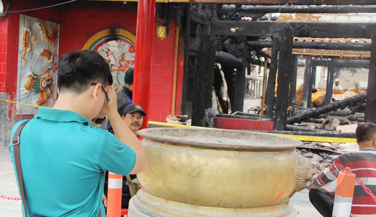 Seorang warga sembahyang di depan sisa-sisa kebakaran Wihara Dharma Bakti, Petak Sembilan, Jakarta, Kamis (19/3/2015). Wihara yang lebih dikenal dengan Petak Sembilan ini terbakar pada 2 Maret 2015 lalu. (Liputan6.com/Helmi Afandi)