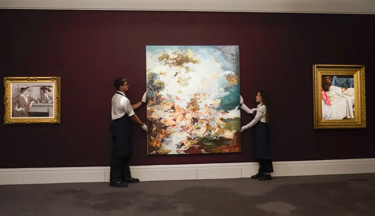 Staf memegang lukisan 'Boucher's Flesh' karya Flora Yukhnovich di Sotheby's, London, Inggris, 22 Juni 2022. Lukisan yang akan dilelang pada 29 Juni 2022 itu diperkirakan memiliki harga 200.000-300.000 pound. (AP Photo/Alberto Pezzali)