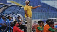 Pelatih tim PON Jatim, Rudy Keltjes, memberikan instruksi kepada anak asuhnya ketika beruji coba dengan Arema FC di Stadion Kanjuruhan, Malang, Kamis (10/9/2020). (Bola.com/Iwan Setiawan)