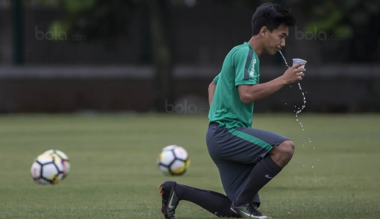 Gelandang Timnas Indonesia, Muhammad Iqbal, melepas dahaga saat latihan di Lapangan ABC Senayan, Jakarta, Jumat (19/1/2018). Pemusatan latihan ini dilakukan jelang Asian Games 2018. (Bola.com/Vitalis Yogi Trisna)