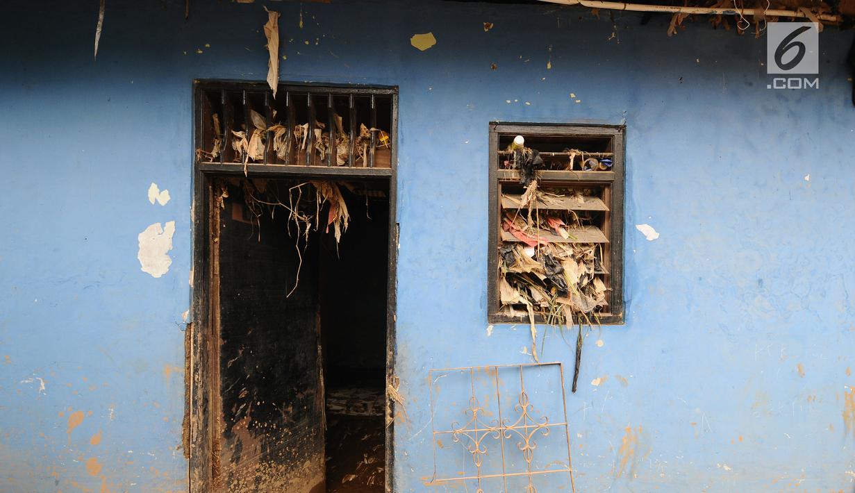 Sampah plastik menyangkut pada jendela dan pintu rumah warga usai banjir melanda kawasan Balekambang, Kramatjati, Jakarta Timur, Selasa (30/4/2019). Sejumlah rumah warga di RT 005/RW 005 Balekambang rusak diterjang banjir yang terjadi pada 27 April 2019 lalu. (Liputan6.com/Herman Zakharia)