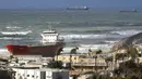 Kapal kargo pembawa semen Zelek Star terdampar di sebuah pantai Kota Ashdod, Israel, Jumat (27/12/20190). Angin kencang dan ombak besar membuat kapal menjauh dari titik jangkar di dekat Pelabuhan Ashdod sehari sebelumnya. (JACK GUEZ/AFP)