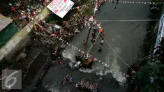 Sejumlah warga memadati bantaran Kali Code untuk menyaksikan lomba panjat pinang, Yogyakarta, Selasa (9/8). Lomba diselenggarakan untuk menyambut HUT RI ke-71. (Liputan6.com/Boy Harjanto)