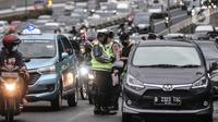 Petugas kepolisian menilang pengendara mobil yang melanggar aturan ganjil genap di Jalan MT Haryono, Jakarta, Kamis (28/10/2021). Direktorat Lalu Lintas Polda Metro Jaya mulai hari ini memberlakukan sanksi tilang kepada pelanggar ganjil genap di 13 ruas jalan DKI Jakarta. (merdeka.com/Iqbal S Nugroh