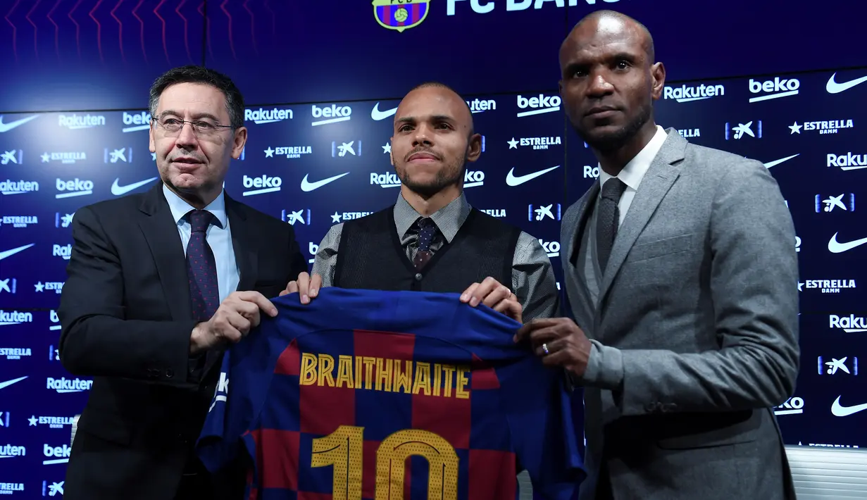 Penyerang baru Barcelona, Martin Braithwaite berpose dengan presiden klub Spanyol Josep Maria Bartomeu dan sekretaris teknis Barcelona Eric Abidal  selama presentasi dirinya di Barcelona, Spanyol (20/2/2020). (AFP/Josep Lago)